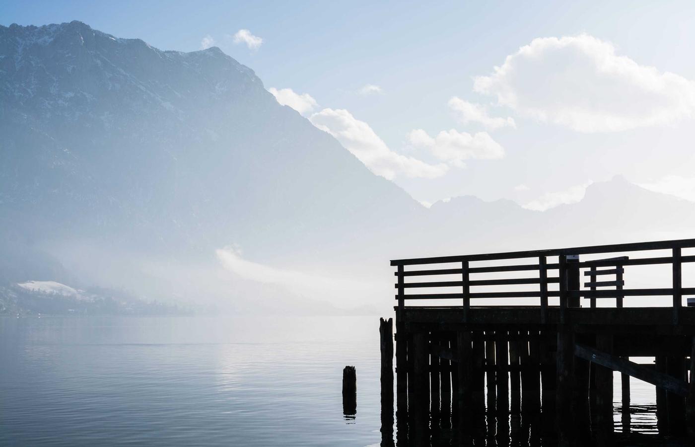 Person using a laptop outdoors with natural scenery